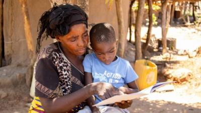 © Denise Clarke, USAID Let's Read project Zambia Mother and boy reading Zambia