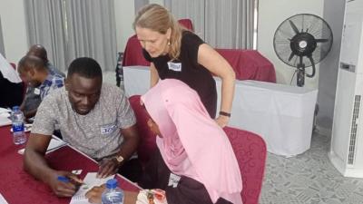 Trainer helping students Tanzania