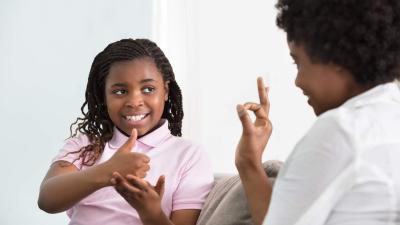 Girl using sign language Girl using sign language
