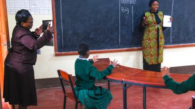 A videocoach filming a primary school teacher during class.